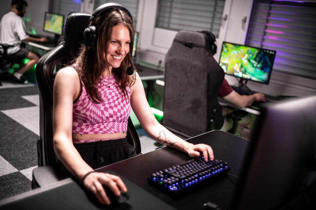 A woman sitting at a desk with a keyboard and mouse