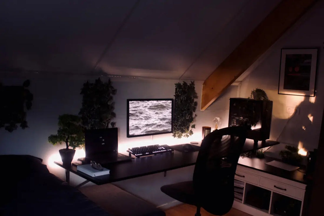 a living room with a desk and a television