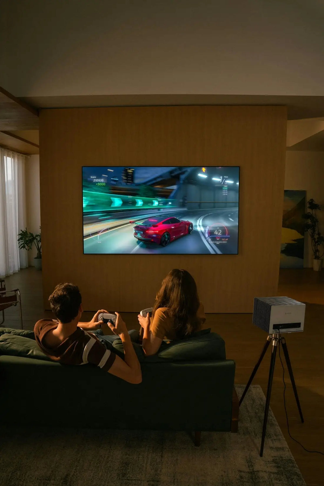 Two people playing a racing video game on television