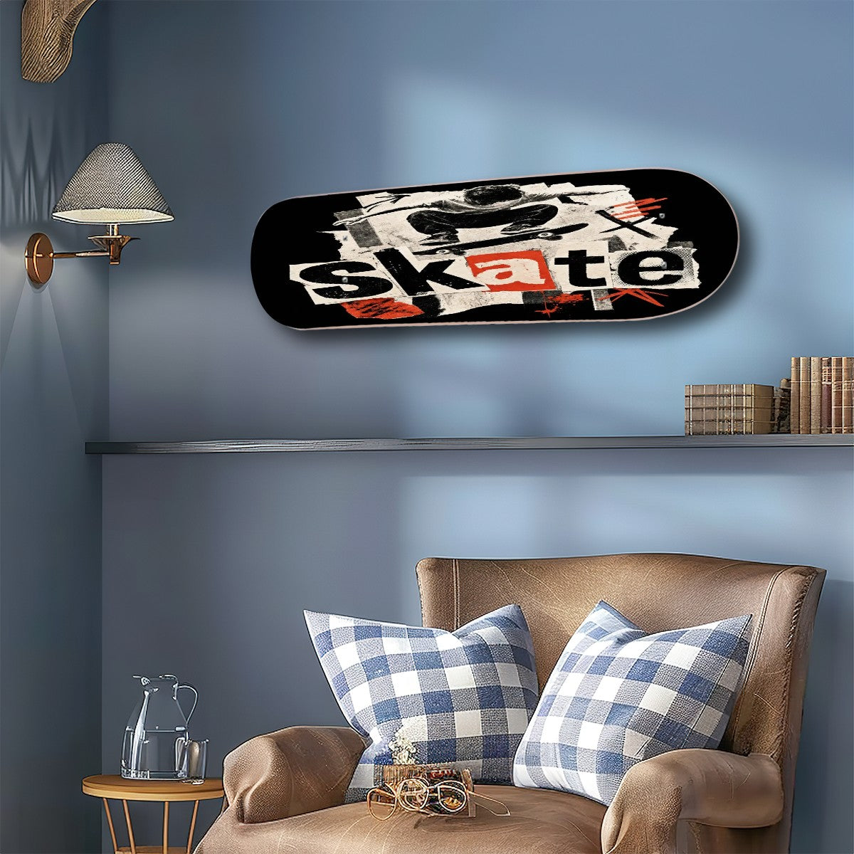 A skateboard wall art print featuring a graphic collage with the word 'skate' in white and orange, mounted on a blue wall above a brown armchair with blue-and-white gingham pillows.