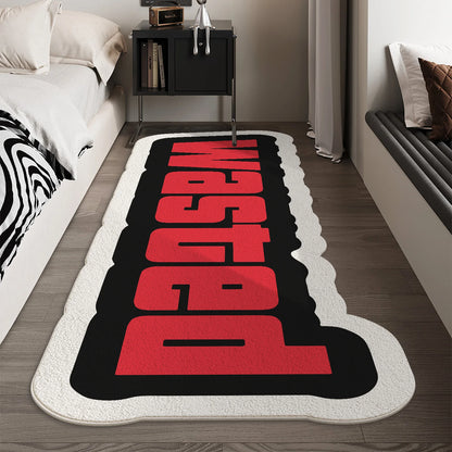 Decorative rug with red and black text in a bedroom setting