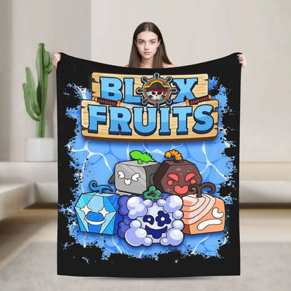 Person holding a 'Blox Fruits' blanket with colorful graphics on a neutral background