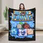 Person holding a 'Blox Fruits' blanket with colorful graphics on a neutral background