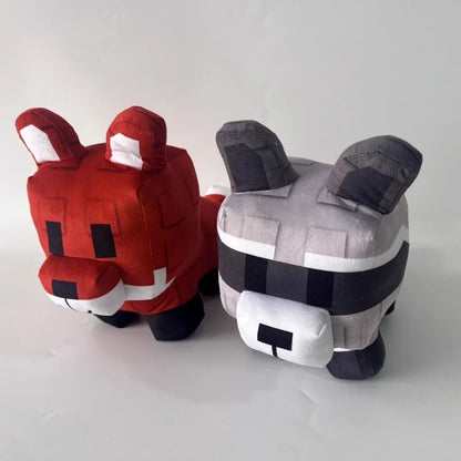 Two plush toys, one red and one gray with black and white accents, on a light gray background.