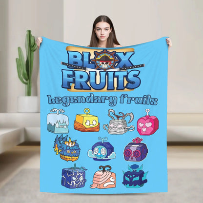 Person holding a blanket with 'Block Fruits' design featuring various fruit-like characters.