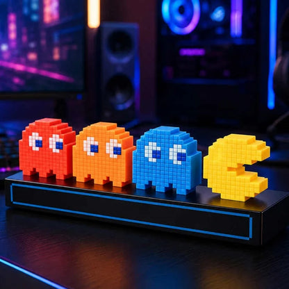 Four pixelated characters on a stand in a gaming setup with colorful lights.