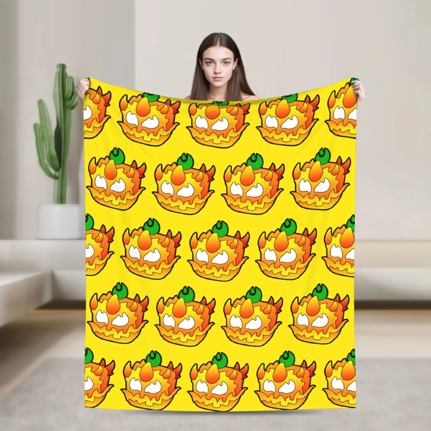 Person holding a large yellow towel with cartoon character pattern