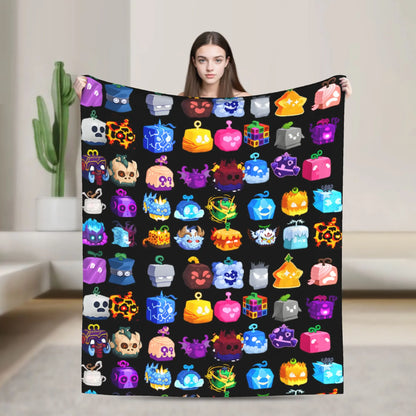 Person holding a colorful blanket with various cartoon-like icons on a black background.