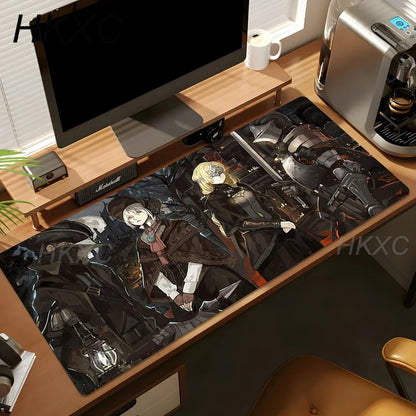A large desk mat with an anime-style illustration of characters in dark, sci-fi armor, shown on a wooden desk next to a computer monitor, coffee maker, and other desk accessories.
