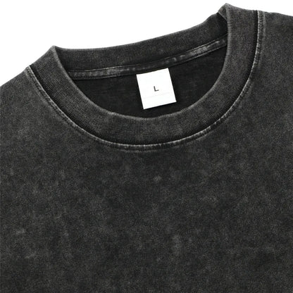 Close-up of a black t-shirt with a size label on a white background