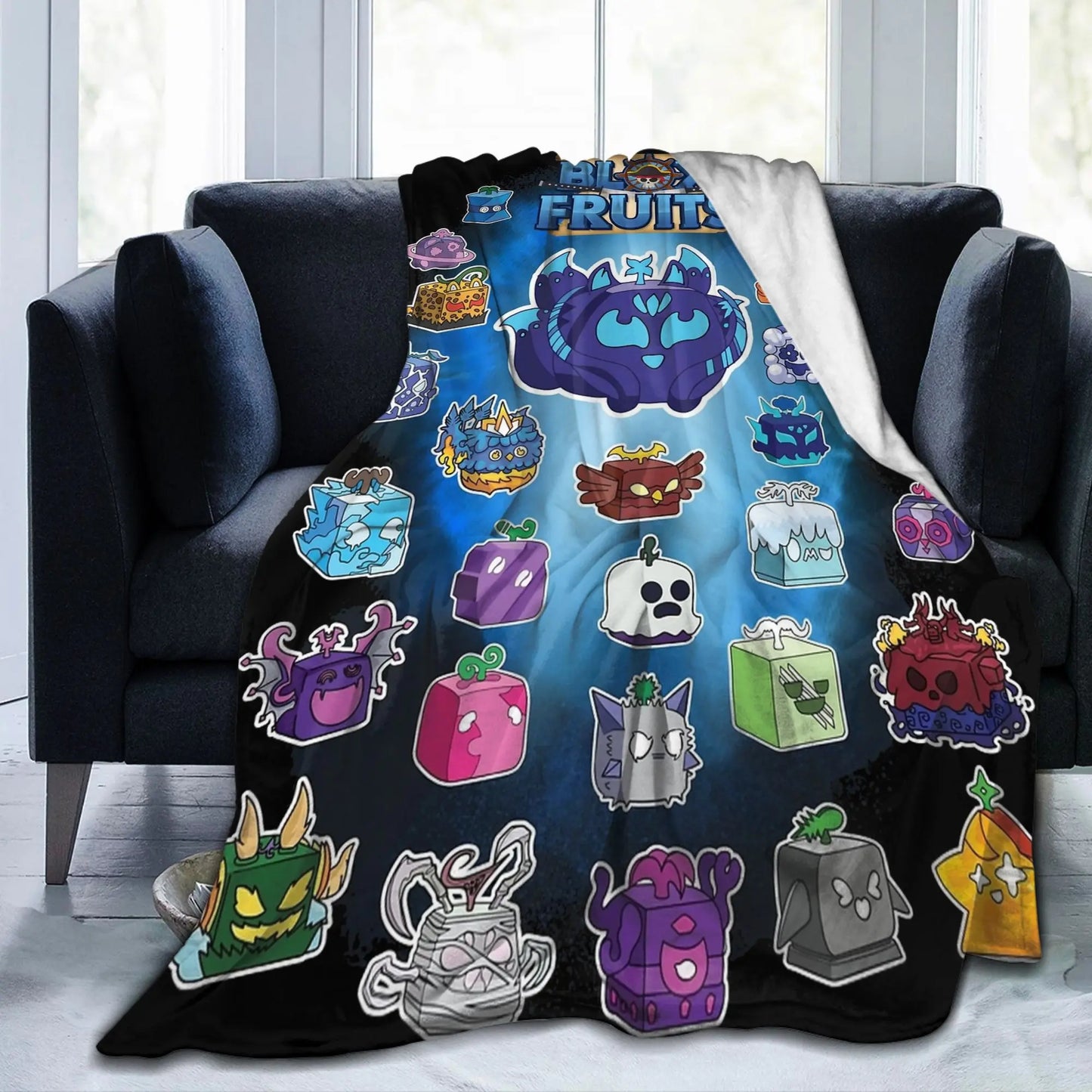 Blanket with colorful cartoon characters draped over a black couch.