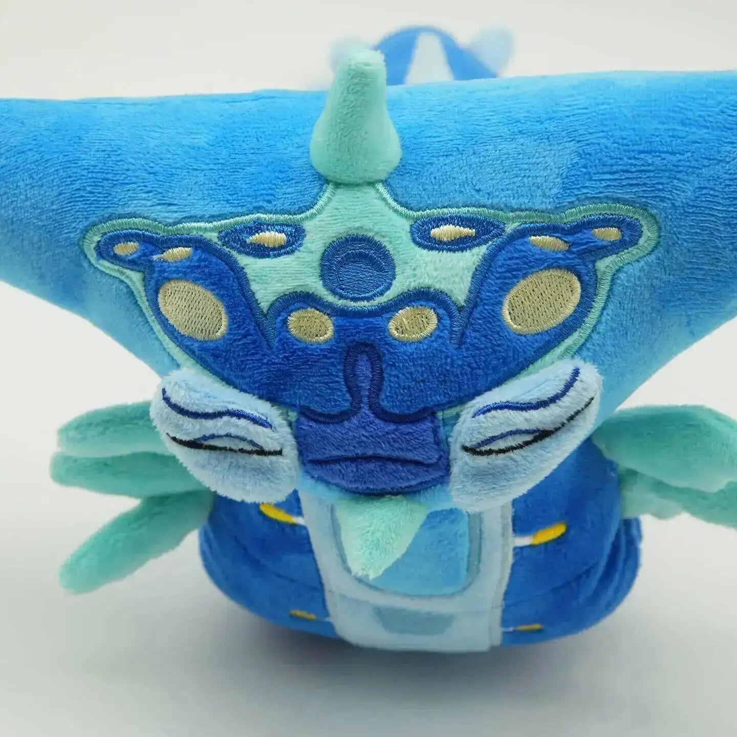 Blue plush toy with a star-shaped design on a white background