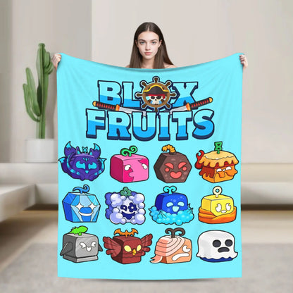 Person holding a 'Blox Fruits' themed blanket with colorful characters on a light background