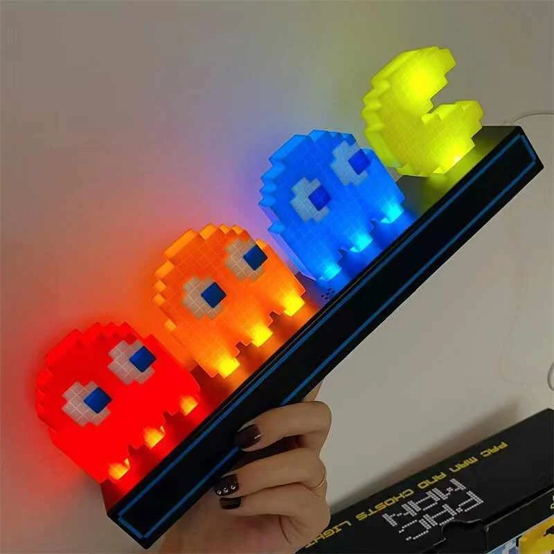 Colorful LED ghost figures held by a hand against a neutral background