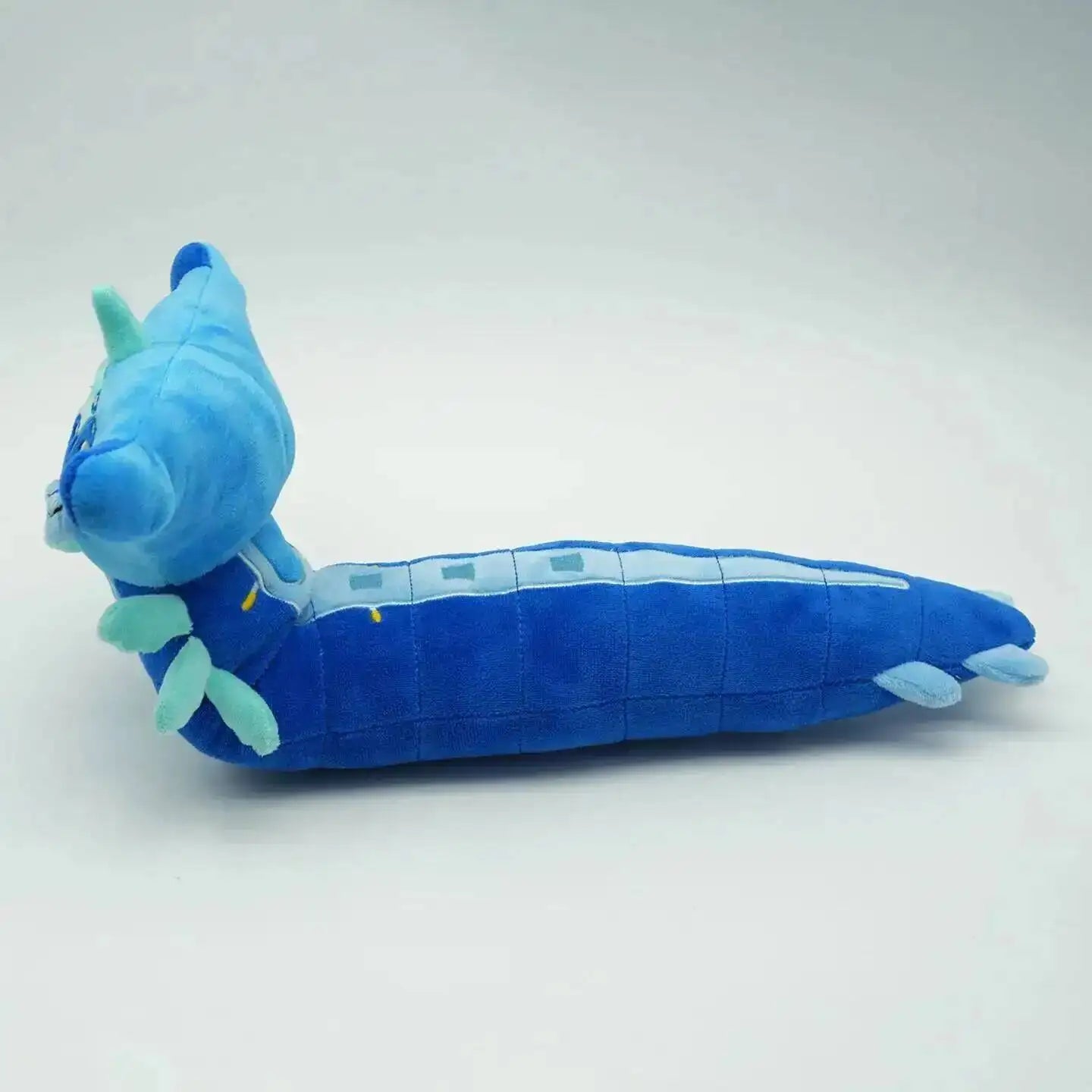 Blue plush toy with a white stripe on a light gray background